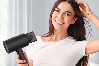 a woman using an ionic hair dryer