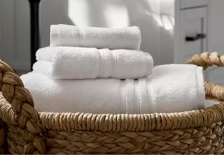 white towel set in a wicker basket