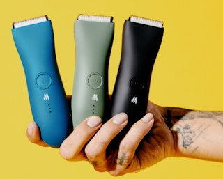 a hand holding three bikini trimmers