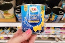 hand holding a can of dole pineapple
