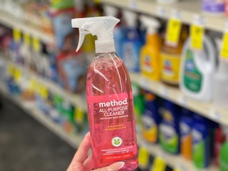 hand holding Method cleaning spray in aisle
