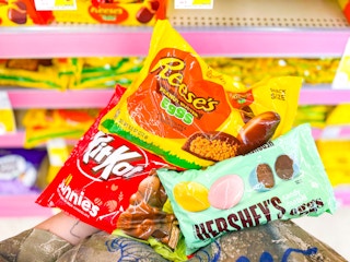hand holding assorted easter candy bags in walgreens