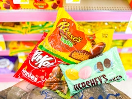 hand holding assorted easter candy bags in walgreens