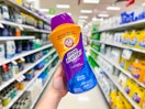 hand holding an arm & hammer scent booster in a target aisle