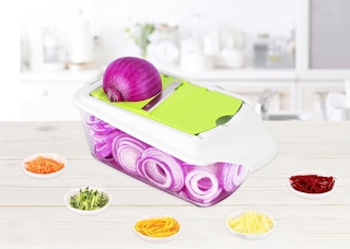 A vegetable chopper with an onion.