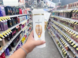 hand holding pantene hair products in walgreens aisle