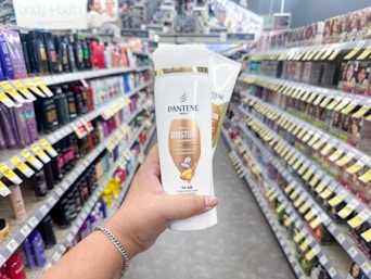 hand holding pantene hair products in walgreens aisle