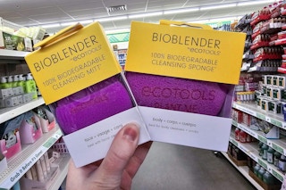 person holding a beauty cleansing sponge and cleansing mitt in an aisle