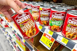 hand holding up a can of campbell's chunky soup at dollar general