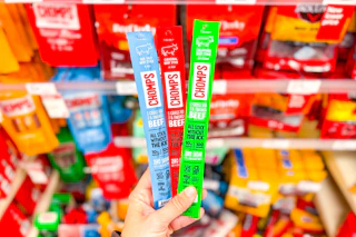 hand holding 3 chomps meat sticks at target