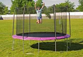 purple trampoline with a safety inclosure