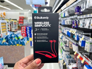 hand holding skullcandy wireless simplicity headphones in aisle