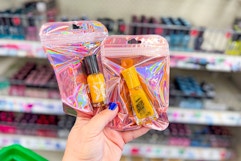hand holding sally hansen nail polishes at dollar tree