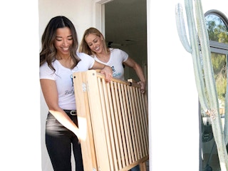 babyquip people carrying out crib from door