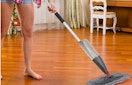 a person mopping hardwood floors 