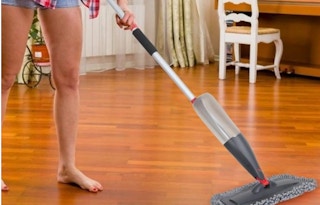 a person mopping hardwood floors 