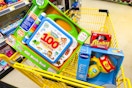 leap frog, vtech, and slinky toys in a yellow shopping cart