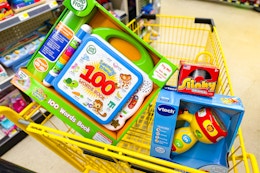 leap frog, vtech, and slinky toys in a yellow shopping cart