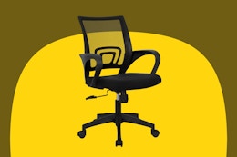 A black rolling desk chair with one lever beneath the seat and a square back made of supportive netting