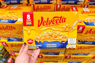 hand holding a pack of velveeta shells and cheese
