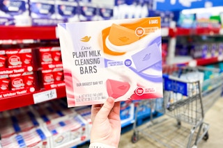 person holding a 6-pack of dove plant milk bar soap