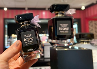 someone holding up a perfume tester