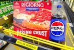 digiorno pizza and pepsi in dollar general shopping cart
