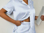 a person wearing blue and white striped pajamas