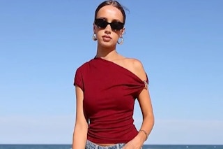 a woman wearing a top at the beach
