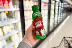 hand holding a bottle of shamrock farms chocolate milk