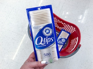 hand holding a box of q-tips cotton swabs at target