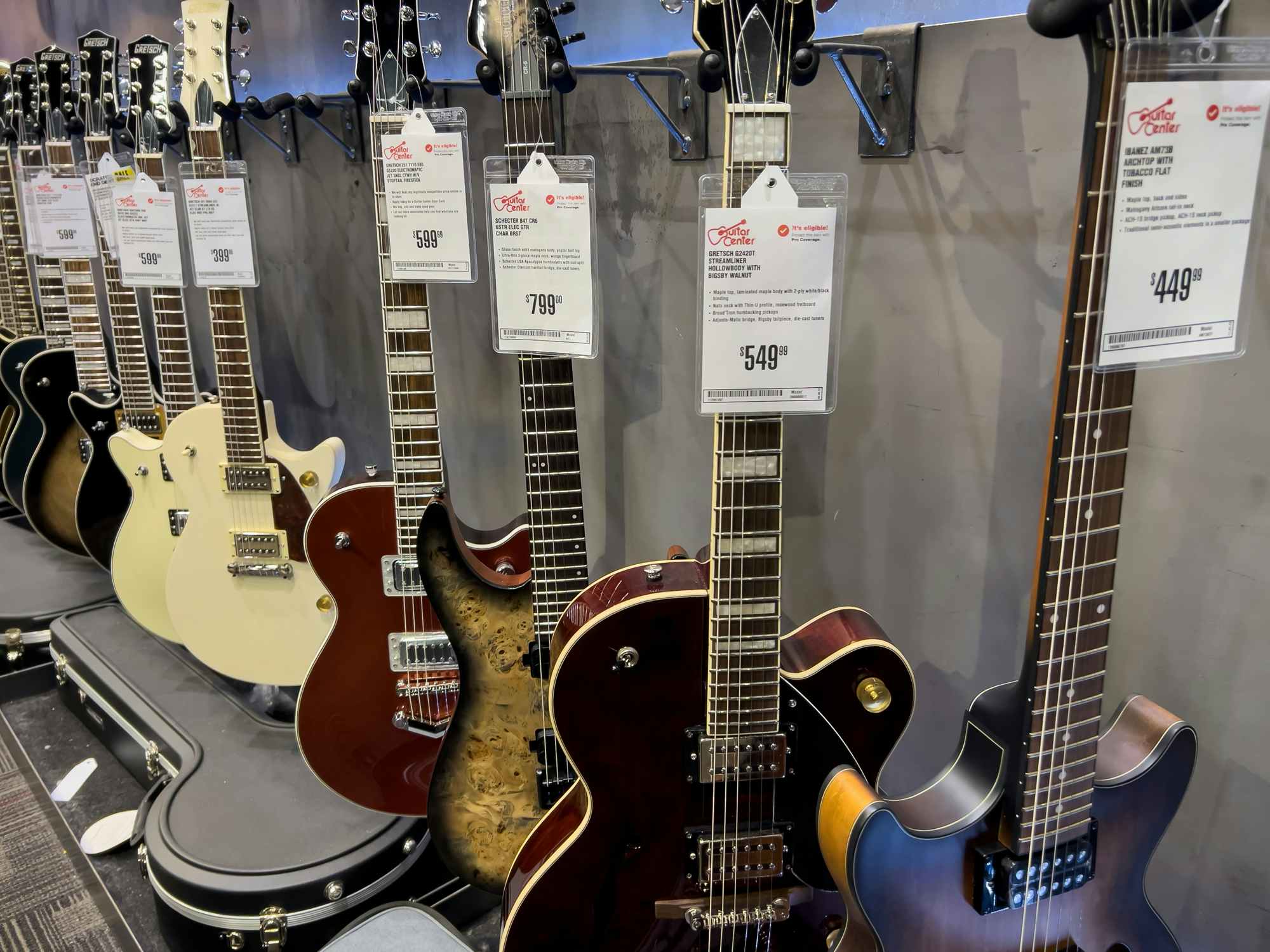 guitars lined up inside of the guitar store