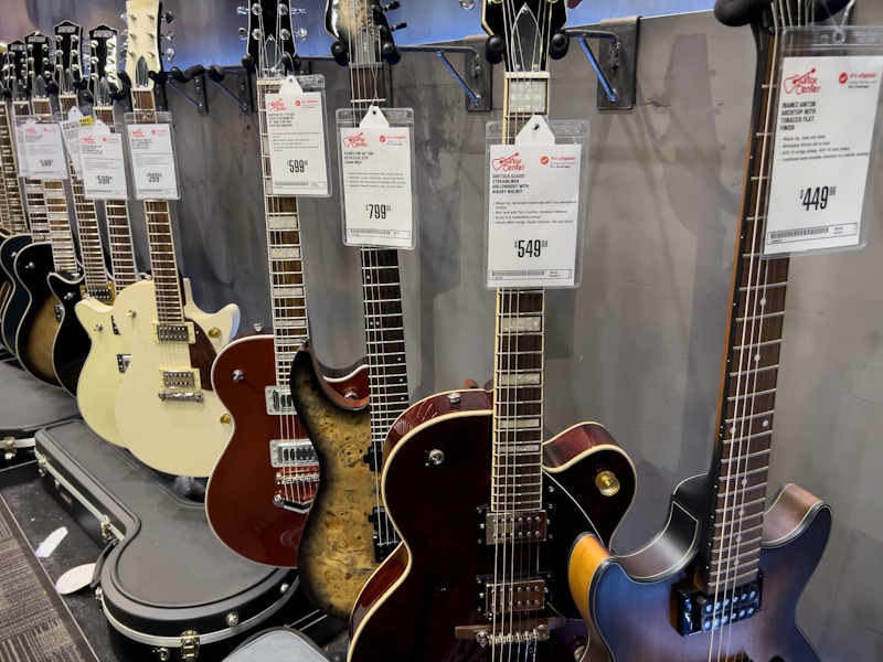 guitars lined up inside of the guitar store