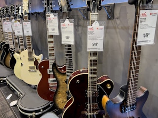 guitars lined up inside of the guitar store