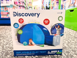 someone holding a discovery kids dome tent
