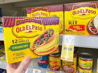 An Old El Paso crunchy tacos box held out net to another Old El Paso Box sitting on a store shelf.
