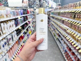 hand holding dove shampoo in walgreens