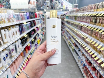 hand holding dove shampoo in walgreens