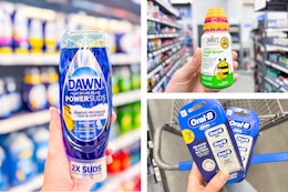 hand holding dawn power suds, zarbees cough syrup and oral b glide floss in walmart aisle