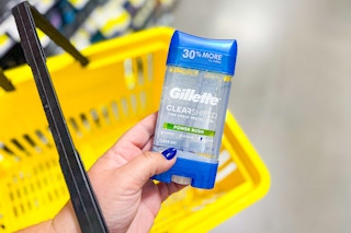 hand holding gillette deodorant above a yellow basket