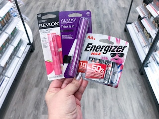 hand holding revlon lip balm almay mascara and energizer batteries at target