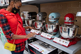 A woman looking at KitcheAid stand mixers