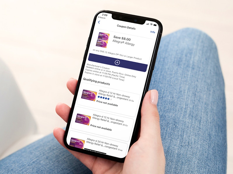 person holding an iphone and looking at a walgreens mobile coupon for allegra
