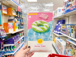 A person holding a Sun Squad pool float at Target.