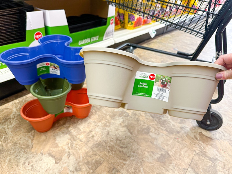 person holding a stackable planter by others