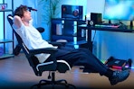 Lifestyle image of young man reclining in he Gtracing Gaming Chair in room setting