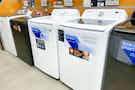 washing machines lined up in aisle at Home Depot
