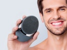 a person holding an electric facial brush