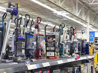 various vacuums from shark, dyson, and more on display at the walmart store
