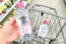 hand holding bottle of Garnier micellar water above another identical bottle in shopping cart